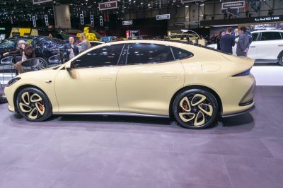 Sleek electric sedan side profile with unique multi-spoke wheels