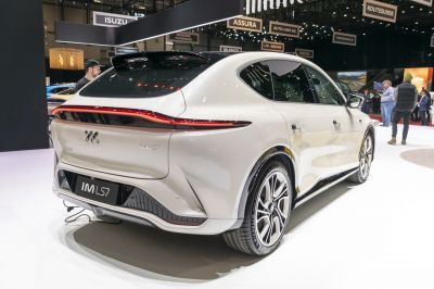 Rear view of modern electric SUV with continuous LED taillight strip