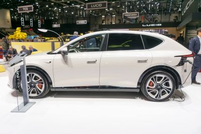 Side profile of electric SUV charging with alloy wheels and sleek design