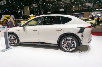 Electric SUV side view with rear charging port and alloy wheels
