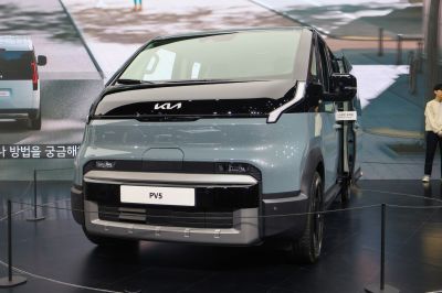 Futuristic compact electric passenger van front design with sleek lights