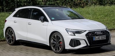 Front grille and alloy wheels of white sporty hatchback