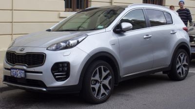 Front side view of SUV with distinctive headlights and alloy wheels