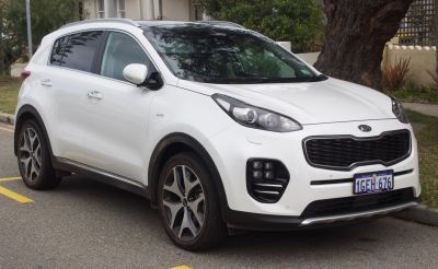 White SUV with distinctive grille and quad fog lights front view