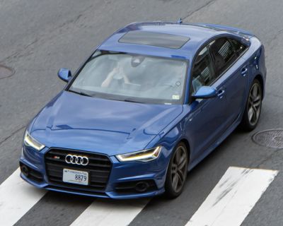 Front view with LED headlights and sunroof on blue sedan