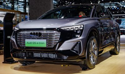 Close-up of front grille and LED headlights on electric SUV.