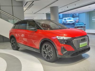 Front side view of red electric SUV with modern design and distinctive headlights