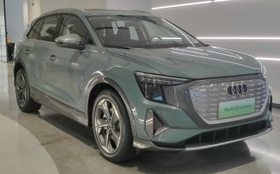 Front and side view of an electric SUV with closed grille and modern angular headlights.