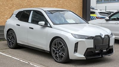 Front and side view with large grille, sleek headlights, unique wheels