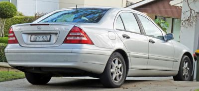 Rear side view of silver sedan with distinctive tail lights and body lines