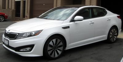 Sleek front side view with distinct headlights and alloy wheels.
