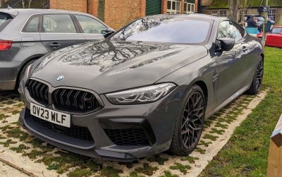 Front angle with aggressive headlights and bold black grille.