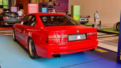 Rear view of a red coupe with dual exhausts and classic taillights