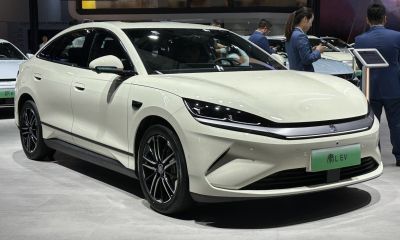 Sleek electric sedan with LED headlights and aerodynamic front design.