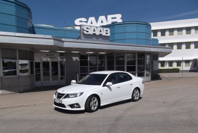 White sedan with sporty front grille and alloy wheels