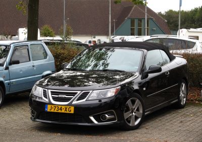 Front view of black convertible with soft top and alloy wheels