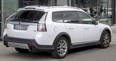 Rear side view of white Saab 9-3X II crossover with alloy wheels