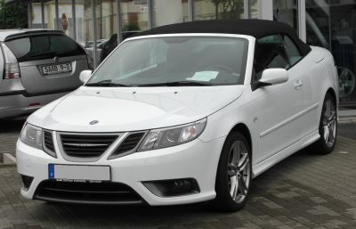 Front view of white convertible with black soft top
