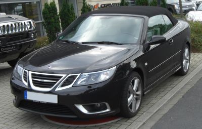 Close-up of front side with chrome grille and soft top convertible roof
