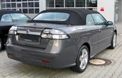 Rear view of convertible with black soft top and clear taillights