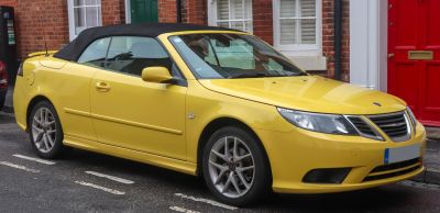 Yellow convertible with black soft top and alloy wheels