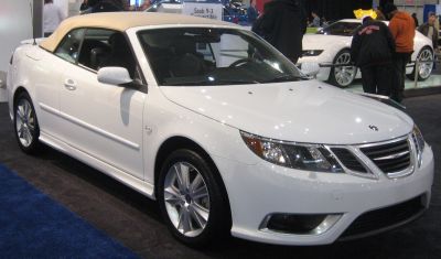 White convertible with beige soft top and sporty alloy wheels