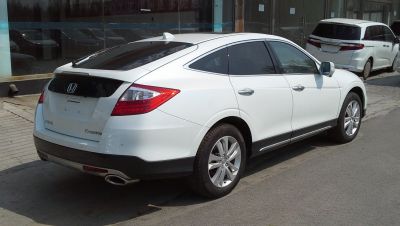 Rear and side profile of a sleek SUV with alloy wheels and distinct rear lights.