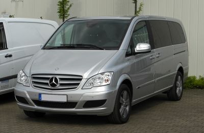 Silver multi-purpose van front view with headlights and grille