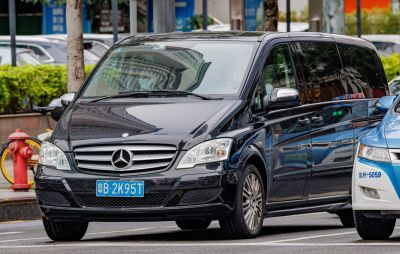 Front view of luxury black van with alloy wheels and prominent headlights