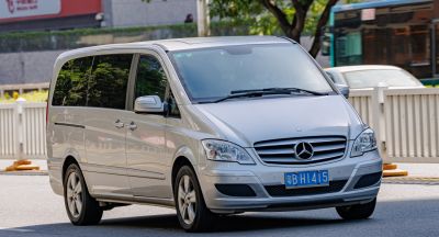 Silver minivan with front-side view, alloy wheels, and tinted windows