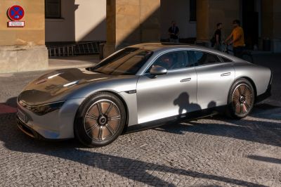 Aerodynamic silver electric car with futuristic wheels and sleek body design