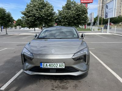 Modern angular headlights and aerodynamic smooth hood in front view