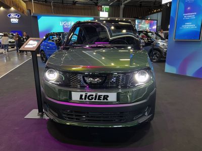 Front view with round LED headlights and black honeycomb grille
