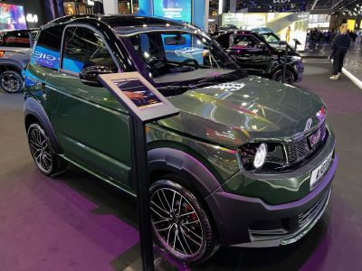 Compact car front side view with sporty alloy wheels and modern headlights