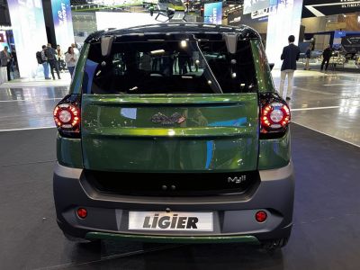 Rear view of compact vehicle with distinctive round taillights and urban-focused design