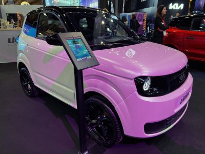 Compact electric vehicle with round headlights and black roof