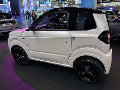 Compact microcar with black alloy wheels and black roof
