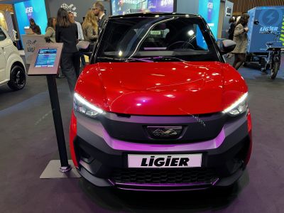 Front view of a sporty vehicle with LED headlights and a sleek black grille.