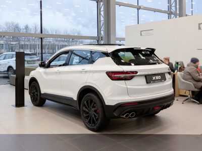 White SUV rear and side view with black wheels and dual exhaust