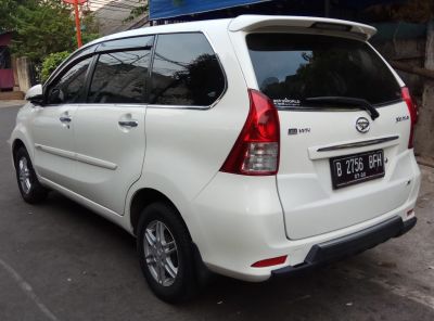 Rear view of white multi-purpose vehicle with alloy wheels and rear spoiler