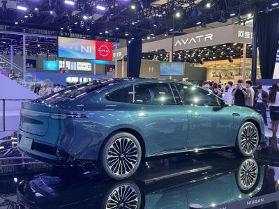 Rear side view of sleek sedan with full-width LED tail light and stylish wheels