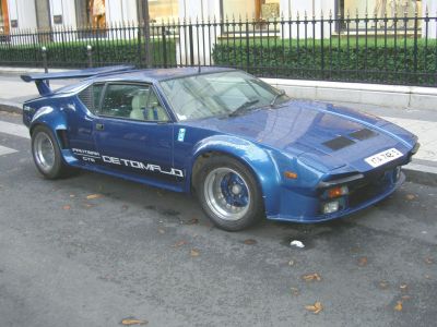 Blue vintage sports car with wide body and rear spoiler