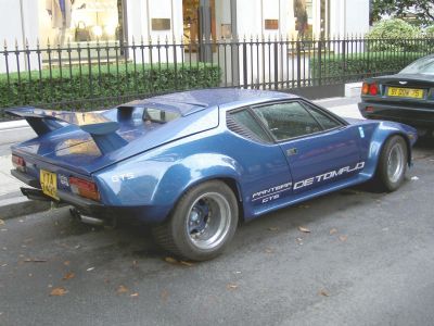 Rear and side view with prominent rear spoiler and wide rear wheel arches