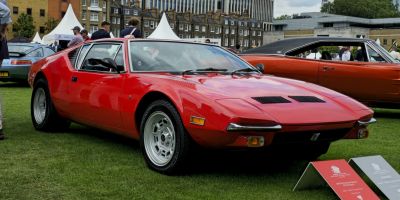 Classic red mid-engine sports coupe with vintage 1970s design.