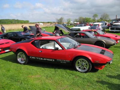 Red and black 1970s muscle sports car with chrome wheels