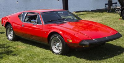 Red sports coupe with pop-up headlights and distinctive rear side vents.