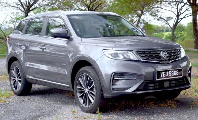 Front side view of an SUV with sleek headlights and alloy wheels
