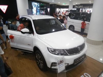 Front view of white SUV with open driver door revealing interior.