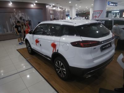 White SUV rear side with red door bows indoors