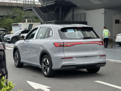 Rear view of crossover with sleek LED taillights and roof spoiler